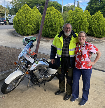 Photo of Emily Moody and a Bloodbiker volunteer