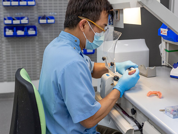 A dentist working on a patient's tooth in a modern dental office.